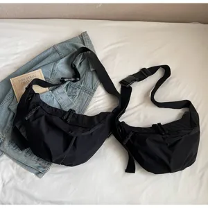 Large capacity black nylon dumpling bag, casual wide strap crossbody bag for women.