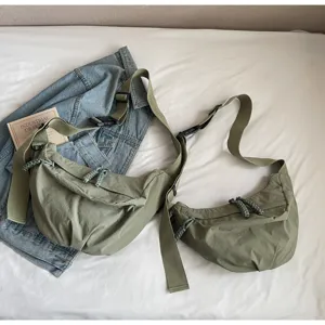 Casual nylon dumpling crossbody bag with wide strap and large capacity for women commuting.