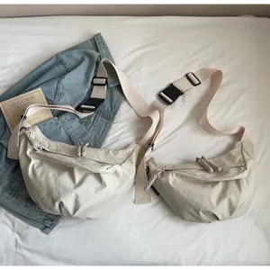 Lightweight nylon crossbody dumpling bag for women, wide strap casual commute and sports bag.