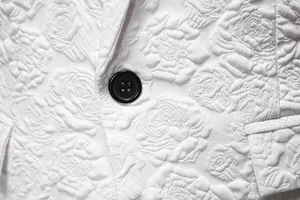 Men business slim fit suit detail, white floral jacquard fabric with black button, stylish.