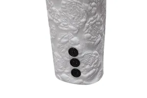 Men's suit sleeve detail, white floral jacquard fabric with black buttons.
