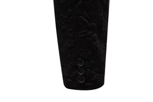 Detailed close-up of black men suit sleeve cuff with elegant jacquard rose pattern and buttons.