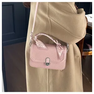 Chic pink shoulder bag for women, featuring textured finish and scarf wrapped handle design.
