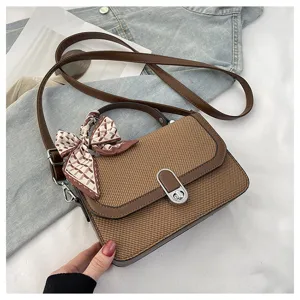Brown woven crossbody shoulder bag detail featuring metallic lock and stylish scarf decor.