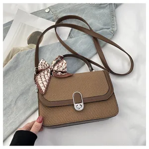 Stylish brown woven shoulder bag for women with chic bow scarf, versatile crossbody handbag.