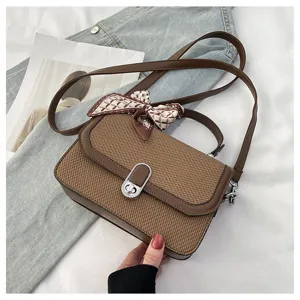 Stylish brown woven shoulder bag for women, chic crossbody bag with elegant bow scarf detail.