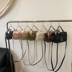 Stylish women's PU leather crossbody handbag with chic scarf accent, multiple solid colors.
