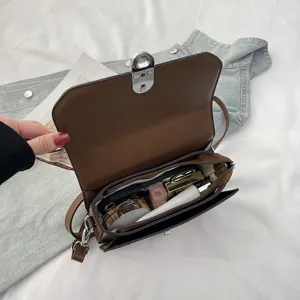 Stylish minimalist women brown crossbody shoulder bag with metal lock and daily space.
