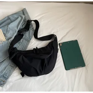Casual nylon crossbody dumpling bag for women, lightweight wide strap commuting shoulder bag.