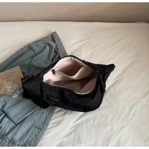 Large capacity black nylon dumpling bag with wide strap, casual commuter crossbody bag.