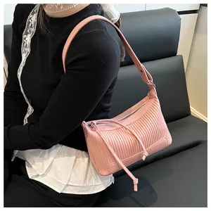 Close-up view of a trendy pink pleated shoulder bag with soft PU leather and chic drawstring.