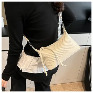 Detail view of a chic beige pleated shoulder bag, stylish retro pillow bag for women daily wear.