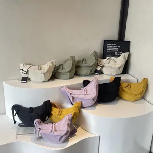 Casual nylon dumpling crossbody bag with wide strap, large capacity daily commuter bag.
