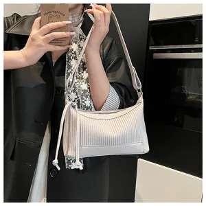 Detailed view of the stylish pleated pillow shoulder bag with fine strap and texture.