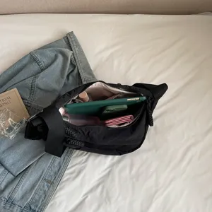 Black nylon crossbody bag with wide strap, large capacity casual commuter dumpling bag.