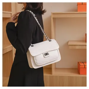 Close-up of a white quilted shoulder bag with chain strap and chic metal lock in studio display.