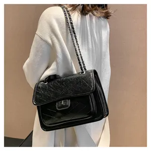 Chic black quilted chain shoulder bag for women, featuring metallic strap and turn-lock detail.