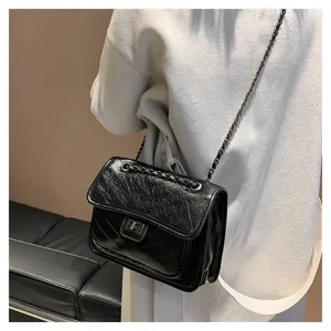 Stylish black quilted leather crossbody bag with a metal chain strap for women daily use.