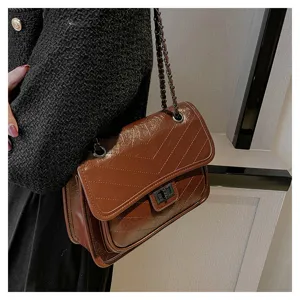Brown chevron quilted chain shoulder bag with twist lock closure for women daily fashion.