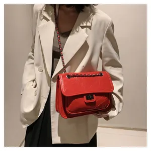 Red patent leather chain shoulder bag detail, stylish women crossbody handbag with flap lock.
