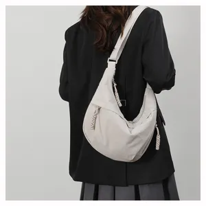 Back view detail of casual nylon dumpling crossbody bag showcasing its soft shape and strap.