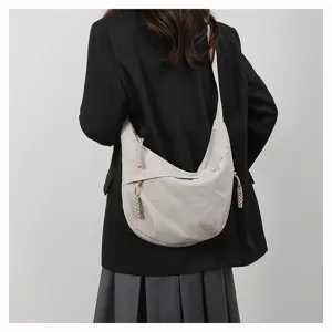 Detail view of casual nylon hobo crossbody bag worn on shoulder, stylish everyday accessory.