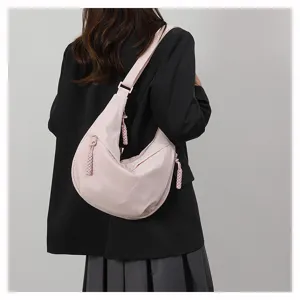 Pink dumpling crossbody bag detail showing casual style and lightweight fabric for women.