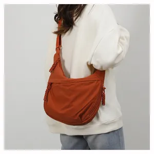 Casual nylon crescent crossbody bag for women, lightweight large capacity shoulder bag for daily use.