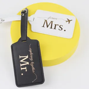 Close-up detail of PU leather couple luggage tags with Mr and Mrs lettering and straps.