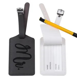 Close-up detail of leather couple luggage tags with Mr embroidery and clear ID card slots.