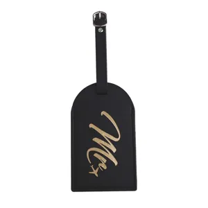 Details of black PU leather luggage tag with gold cursive design and durable metal buckle.
