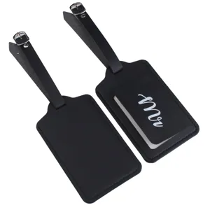 Close-up detail of black PU leather luggage tags featuring adjustable buckle straps and card.