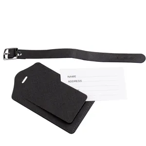 Close-up view of dark brown leather luggage tag featuring buckle strap and name card slot.