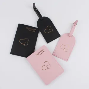 Detail view of heart passport holder and luggage tag set, travel wallet case in black pink.