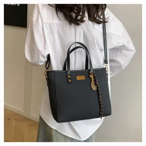 Black large capacity commuter tote bag, stylish woven texture shoulder bag with chic tennis charm.
