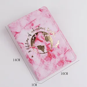 Pink marble passport holder detail showing gold globe pattern and travel quote design.