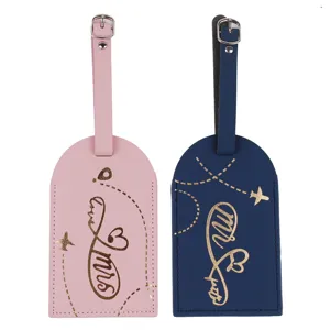 Set di etichette per bagagli in pelle PU rosa e blu scuro con dettagli dorati eleganti.