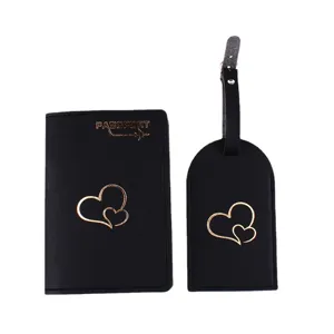 Black leather passport holder and luggage tag set with gold heart design for travel.