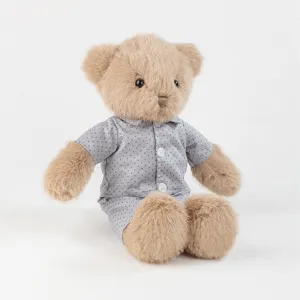 Adorable brown plush teddy bear wearing cute grey dotted pajama set, soft and cuddly gift.