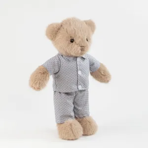 Cute brown teddy bear plush toy wearing grey polka dot pajama set detail view soft doll