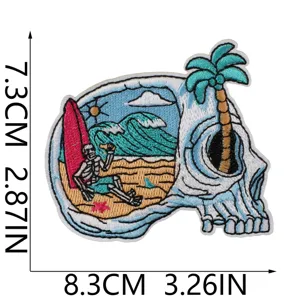 Detailed close up view of the vintage skull surfing embroidery patch with beach scenery.