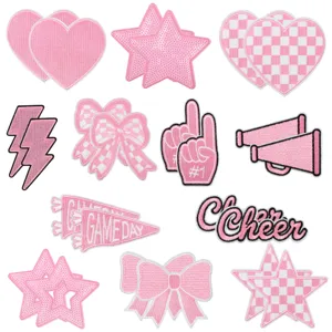 Pink embroidered patch detail featuring cute hearts, bows, stars and cheerleader designs.