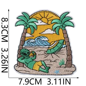 Detailed view of summer Hawaiian alien embroidery patch, featuring beach palm trees and UFO design.