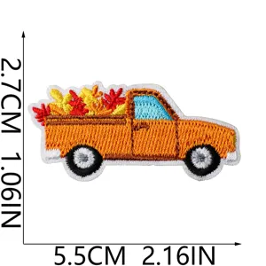 Detailed close-up of autumn harvest pickup truck embroidered patch with vibrant leaves design.