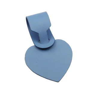 Blue PU leather heart luggage tag detail, smooth texture closeup for travel suitcase accessories.