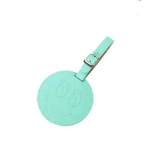 Étiquette de bagage ronde en similicuir PU vert menthe sourire pour valise de voyage.