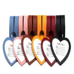 Detail view of colorful heart-shaped PU leather luggage tags with address card inserts.