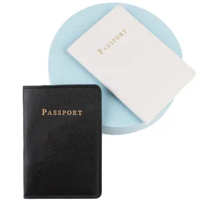 Detailed view of passport holder set in black and white with gold stamped text for travel.