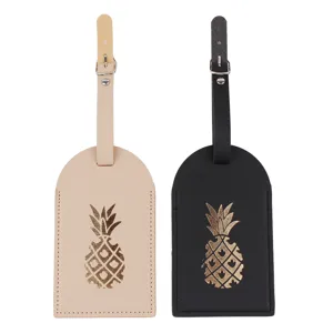 Set di etichette per bagagli in pelle beige e nera con motivo ananas dorato per viaggi.