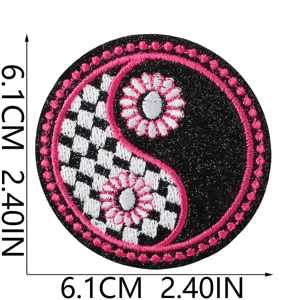 Round embroidered patch with yin yang checkerboard design and pink trim measuring 6.1cm